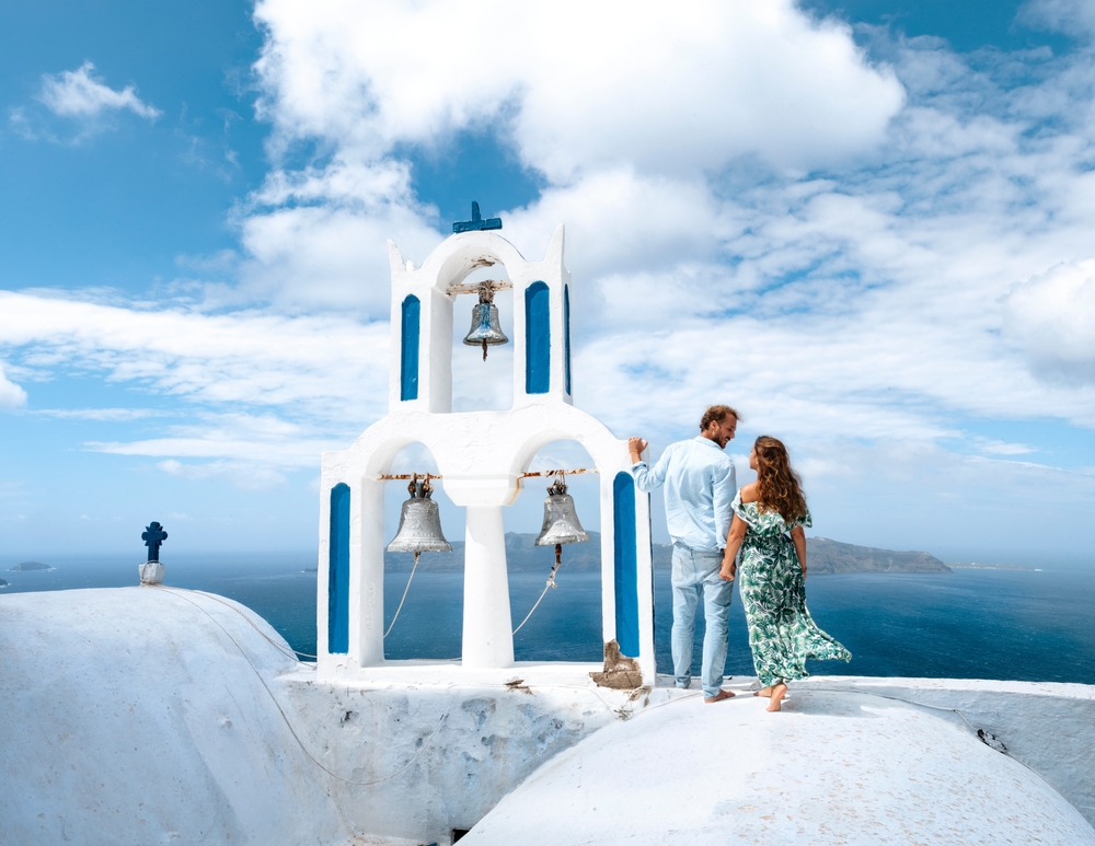 Young,Traveler,Couple,On,Honeymoon,Enjoying,The,Sights,Of,Oia